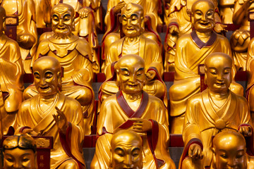A lot of gold statues of the Lohans in Longhua Temple in Shanghai, China. Famous buddhist temple in China.