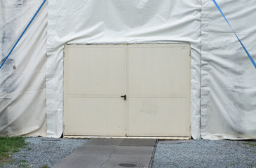 White gate to a festival tent