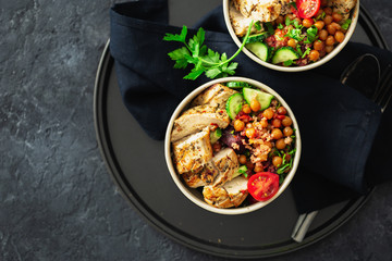 Two bowl buddha. Healthy eating plate top view on dark background with copy space