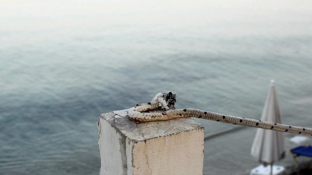 wooden pillars connected with white rope marking the end of the terace