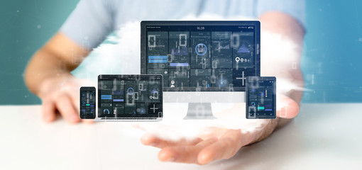 Businessman holding Devices connected to a cloud multimedia network 3d rendering