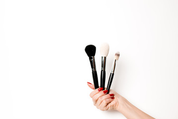 A variety of salon and makeup objects on an isolated white background. Hands are holding mascara,...