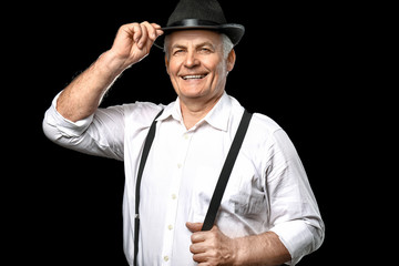 Portrait of stylish senior man on dark background