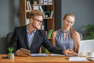 Male and female accountants working in office