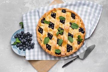 Tasty blueberry pie on grunge background