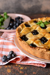 Tasty blueberry pie on table