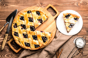 Tasty blueberry pie on wooden table