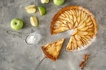 Tasty apple pie on grunge background