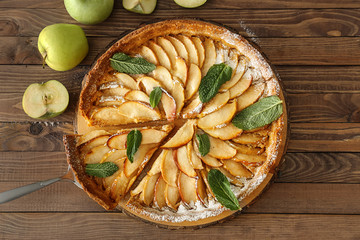 Tasty apple pie on wooden table