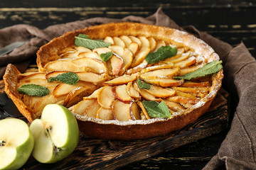 Tasty apple pie on wooden board
