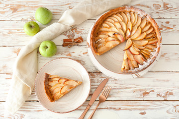 Tasty apple pie on white wooden table