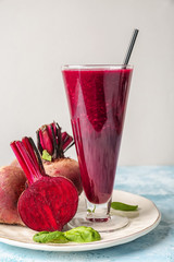 Glass of fresh beet smoothie on table
