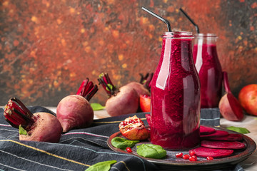 Bottles of fresh beet smoothie on table