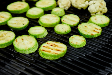 Grilled zucchini vegetable on huge gas grill . Vegan food. Diet, healthy Picnic. Summer. Top view. Flat lay. Copy space..