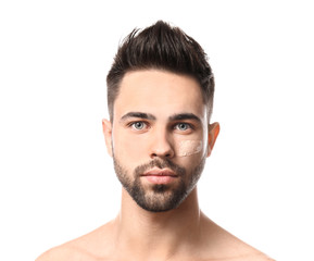 Handsome man with cosmetic clay on his face against white background