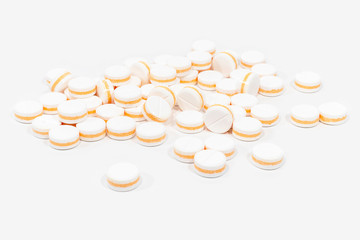 White pills, painkillers on a white background. Concept healthcare and medicine.