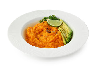 Plate with mashed sweet potato and avocado on white background