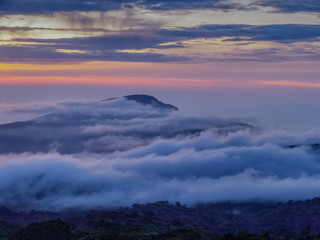 sunrise at Doi Inthanon, mountain view morning of peak mountain Doi Hua Suea around with sea of fog with red sun light in the sky background, KM.41 view point Doi Inthanon, Chiang Mai, Thailand.