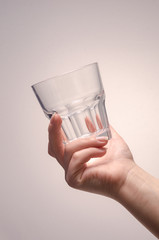 hand holding a glass on a white background. isolate