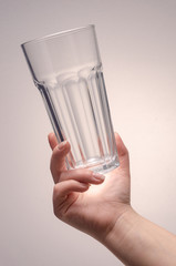 hand holding a glass on a white background. isolate