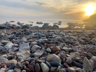 stones on beach at sunset