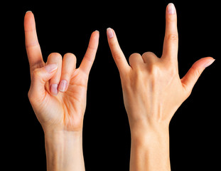 Set of women's hands showing rock n roll sign or giving the devil horns gesture