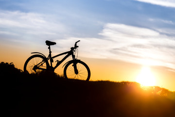 Mountain bike on the background of sunset.