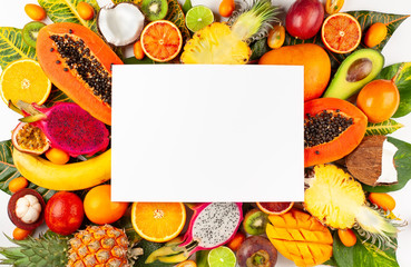 Still life with fresh assorted exotic fruits on a palm leaf.