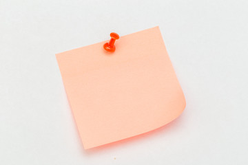 Note with a paper clip. Isolated on a white background
