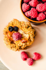 Oatmeal cookies with raspberry jam and date caramel. Close-up.