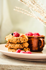 Homemade oatmeal cookies with fresh berry on old wood table background. Healthy Food Snack Concept. Copy space.