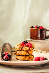 Oatmeal cookies with raspberry jam and date caramel. Close-up.Kinfolk and comfort food atmosphere concept.