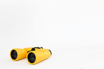 yellow marine optical plastic binoculars on a white background