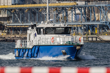 MODERN MOTORBOAT - The fast boat of the naval office is maneuvering in the seaport