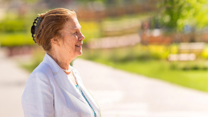 Portrait of beautiful senior woman in the street