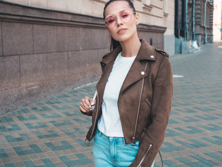 Portrait of beautiful brunette model dressed in summer hipster jacket clothes. Trendy girl posing...