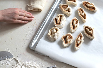 Children mold cheesecakes from dough. Kitchen table in flour. Warm relationships children