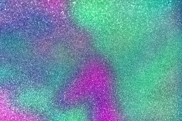 Abstract blurred of green and purple glittering shine bulbs lights background blur of Christmas wallpaper decorations concept.