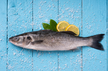 Sea bass on blue wooden background