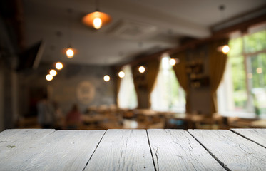 Empty wooden table in front of abstract blurred background of coffee shop . can be used for display or montage your products.Mock up for display of product