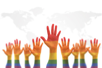 LGBT equal rights movement and gender equality concept with rainbow flag on people's hands up