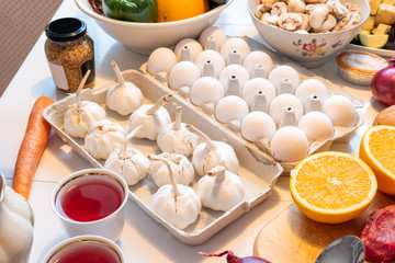 Garlics with eggs on tray with fruits and meat preparing for cooking