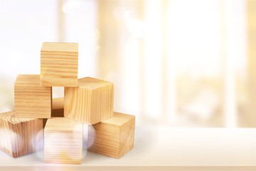 Wooden cubes on table background