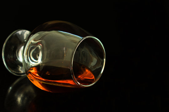 glass of cognac on a black background.Copy space