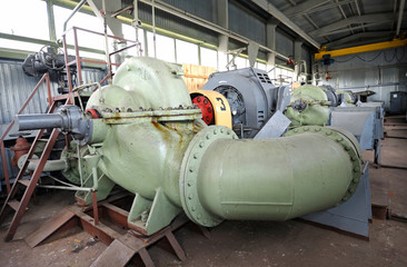 Water pumps and engines set in the hall of the floating pump station. It  provides drinking water to the city