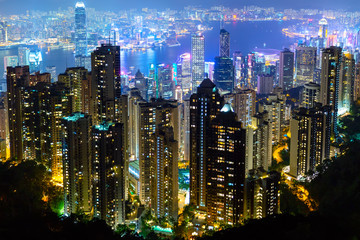 Naklejka premium The most famous view of Hong Kong at twilight sunset. Hong Kong skyscrapers skyline cityscape view from Victoria Peak illuminated in the evening. Hong Kong, special administrative region in China.