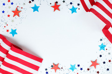 4th of July. Concept for Independence Day with red and blue paper stars confetti and flag in...