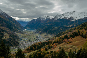 Scenic view from the train to the valley in Switzerland. Small town and lake among town in Switzerland. Adventure in journey. Beautiful nature in autumn. Travel to Europe