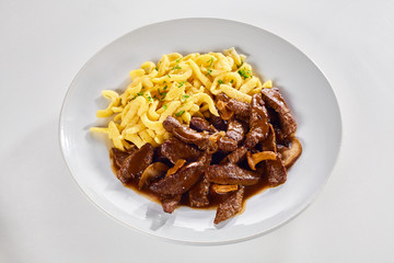 Serving of tasty Swiss ragout with noodles