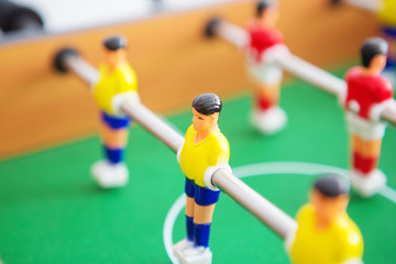 Table football game with yellow and red players and white goalkeeper. Table soccer game.